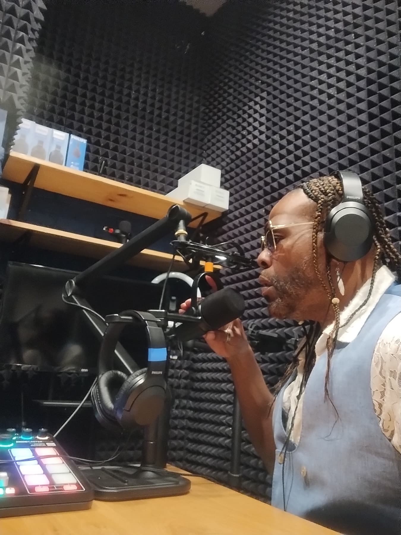 Dr. Fain recording in a podcast booth with headphones and microphone